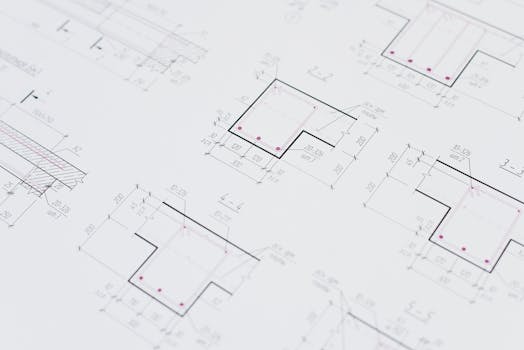 High-resolution close-up of detailed architectural blueprints showcasing precision design layouts.